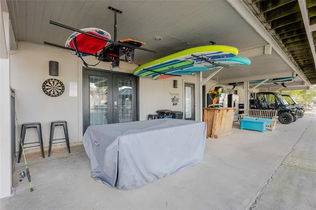 a bed room with a bed mirror and a chair