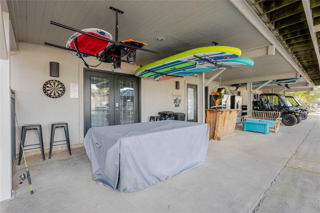 3005 Upcreek Alley, Unit 4 Strawn, TX 76475 - Photo 15 of 29 a bed room with a bed mirror and a chair