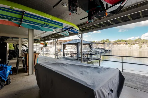a dining room with a glass top table and chairs