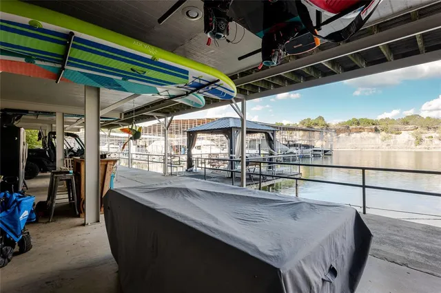 a dining room with a glass top table and chairs