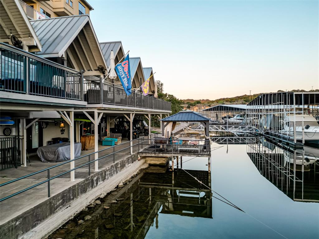 3005 Upcreek Alley, Unit 4 Strawn, TX 76475 - Photo 21 of 29 a view of a house with wooden deck
