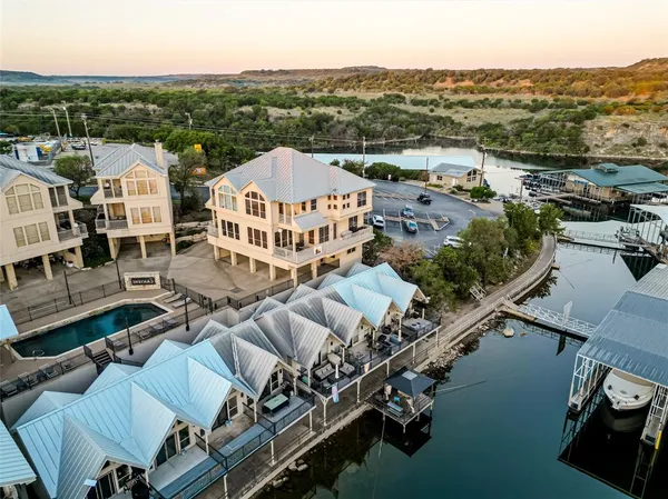 an aerial view of a house with yard swimming pool and ocean view