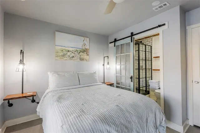 a bedroom with a large bed and a chandelier