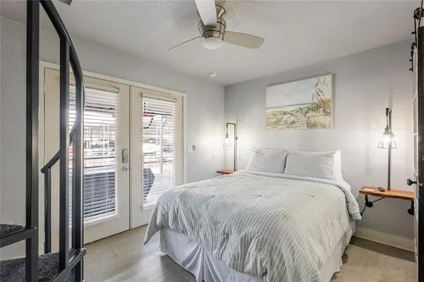 a spacious bedroom with a bed and a large window