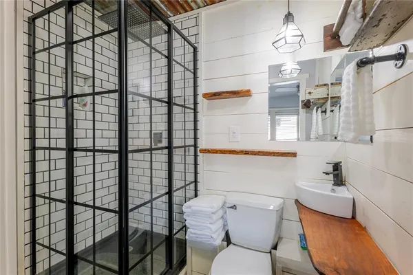a bathroom with a toilet sink and mirror