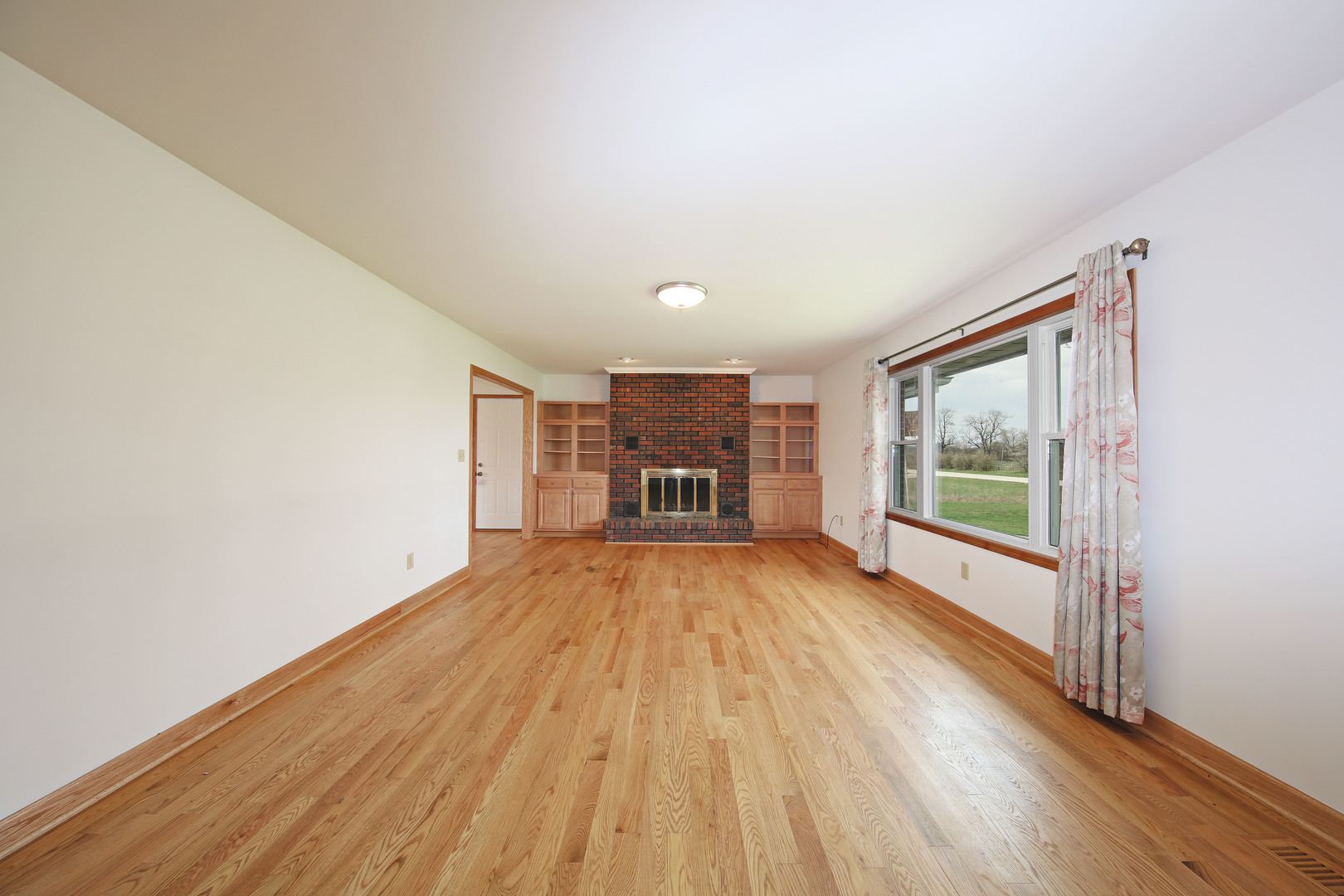 23525 Widows Road Wilmington, IL 60481 - Photo 2 of 17 wooden floor in an empty room with a window