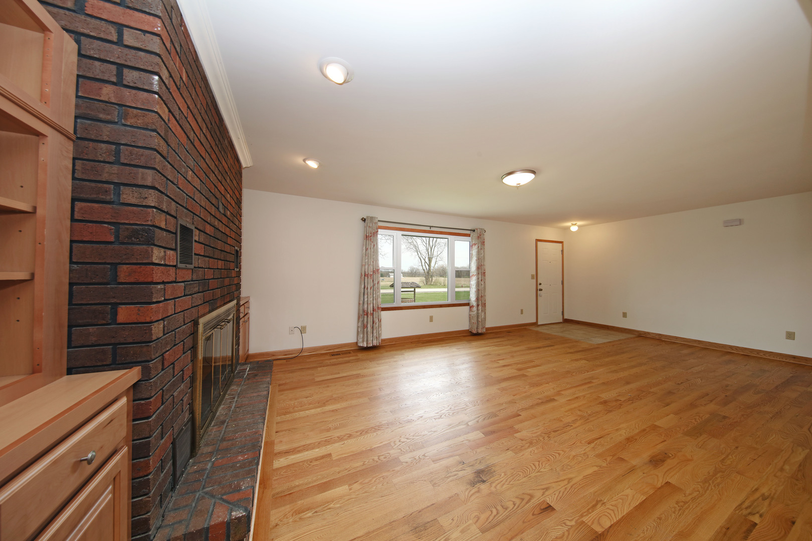 23525 Widows Road Wilmington, IL 60481 - Photo 3 of 17 an empty room with wooden floor and windows