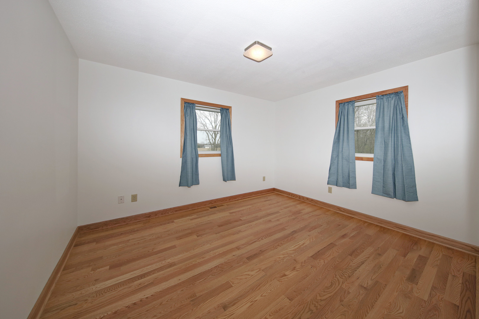 23525 Widows Road Wilmington, IL 60481 - Photo 6 of 17 a view of empty room with wooden floor and fan