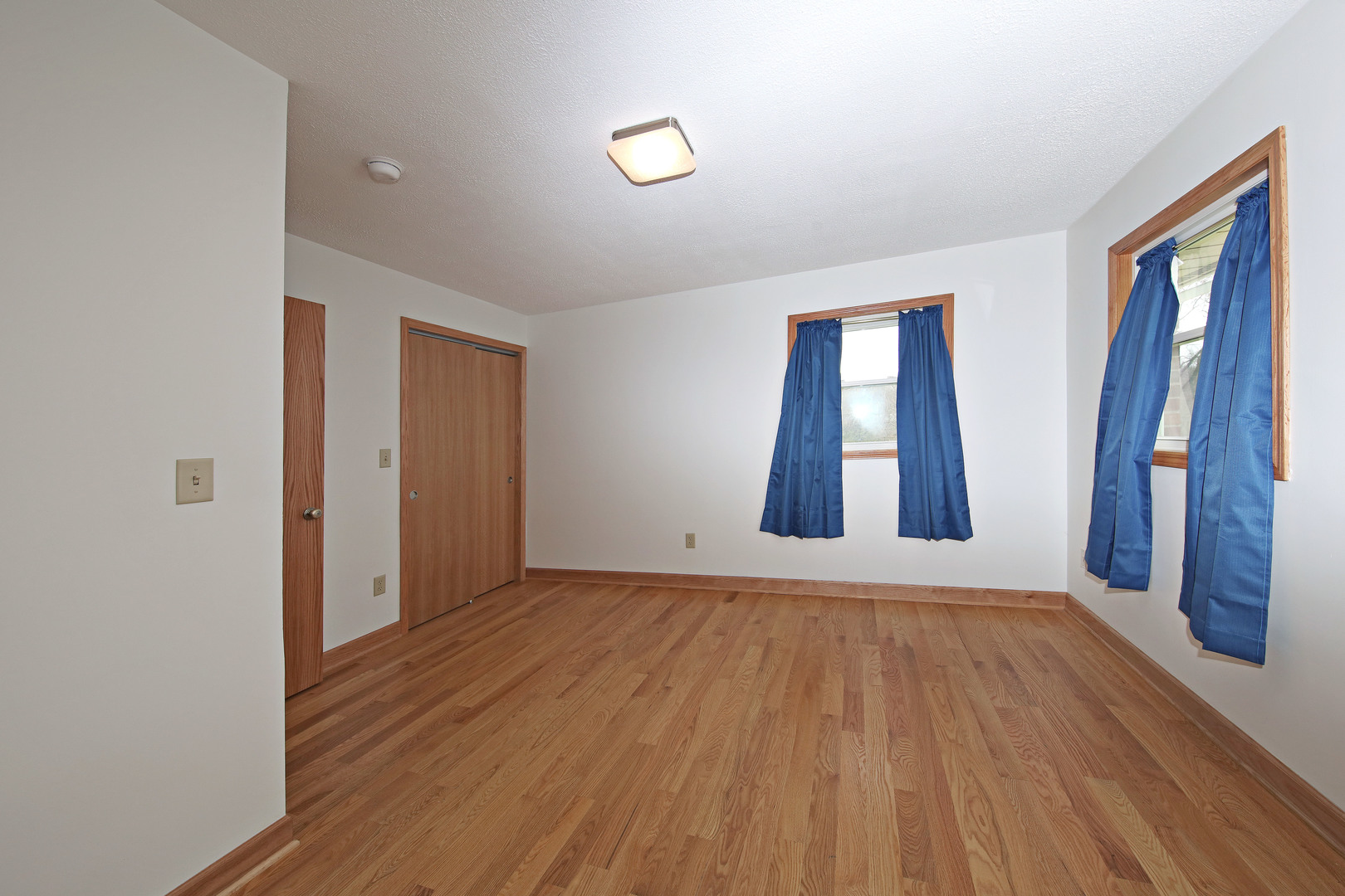 23525 Widows Road Wilmington, IL 60481 - Photo 7 of 17 an empty room with wooden floor and windows