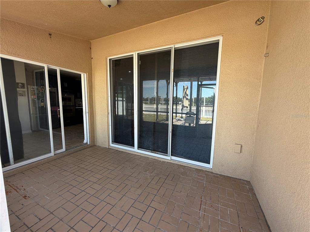 945 Tramells Trail Kissimmee, FL 34744 - Photo 26 of 36 a view of an empty room with glass door