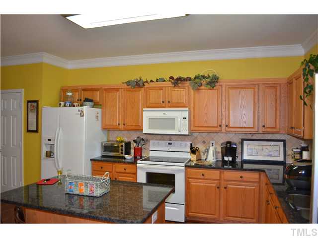 5853 Parkchester Road Raleigh, NC 27616 - Photo 4 of 19 a kitchen with stainless steel appliances granite countertop a refrigerator and stove