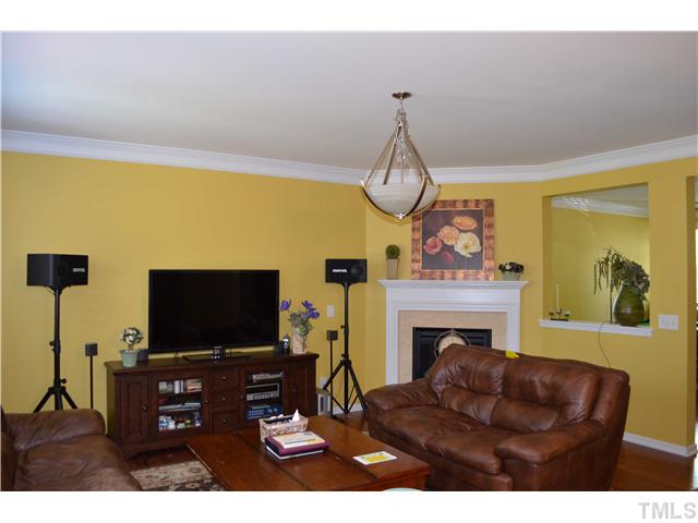 5853 Parkchester Road Raleigh, NC 27616 - Photo 5 of 19 a living room with furniture a flat screen tv and a fireplace