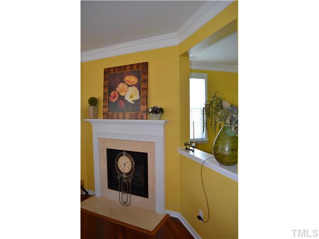 5853 Parkchester Road Raleigh, NC 27616 - Photo 7 of 19 a living room with a fireplace and a table
