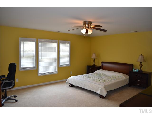 5853 Parkchester Road Raleigh, NC 27616 - Photo 8 of 19 a bedroom with a bed and a desk