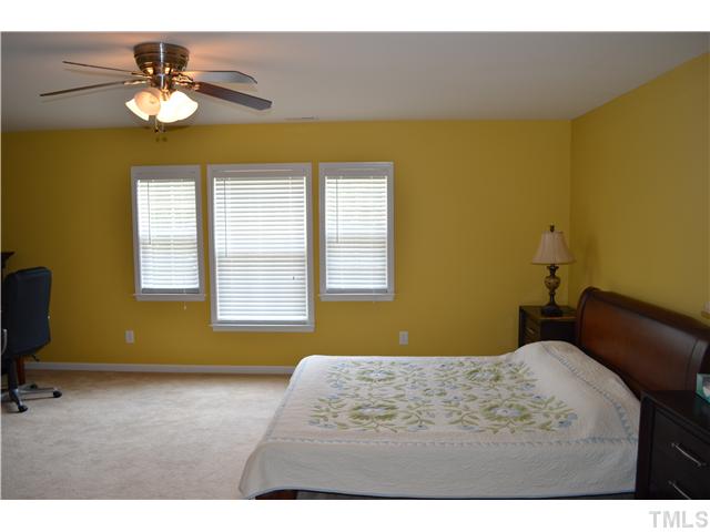 5853 Parkchester Road Raleigh, NC 27616 - Photo 9 of 19 a bedroom with a bed and a chandelier