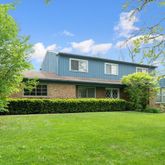 a view of a brick house with a yard