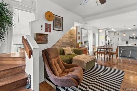 a dining room with furniture and wooden floor