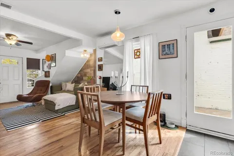 a dining room with furniture and wooden floor