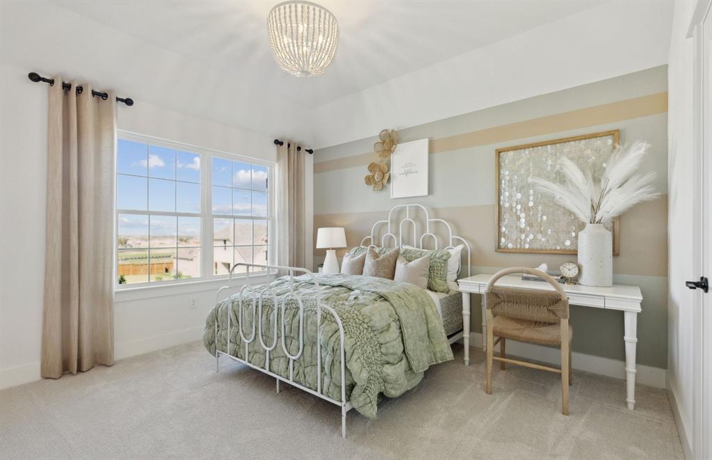 11129 Carham Street Haslet, TX 76052 - Photo 14 of 19 a spacious bedroom with a bed and a table chair