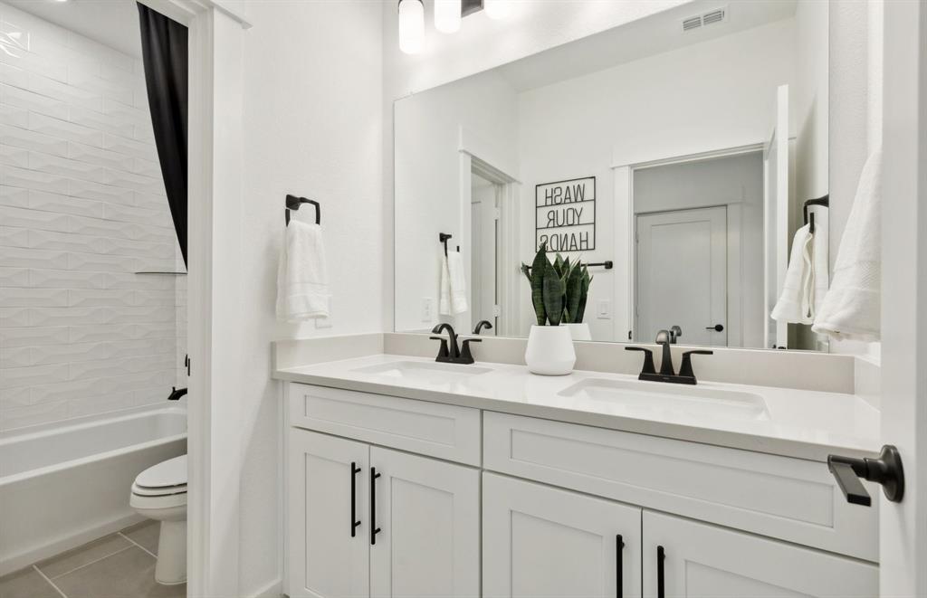 11129 Carham Street Haslet, TX 76052 - Photo 18 of 19 a bathroom with a double vanity sink toilet and shower