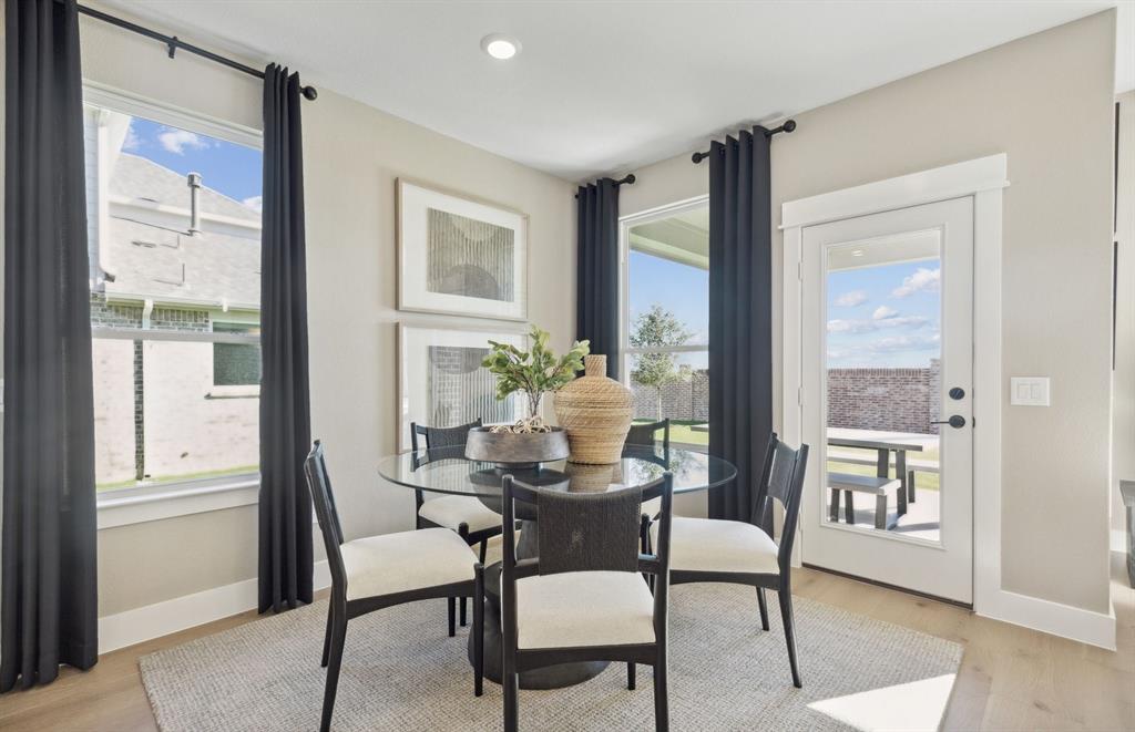 11129 Carham Street Haslet, TX 76052 - Photo 7 of 19 a dining room with furniture window and wooden floor
