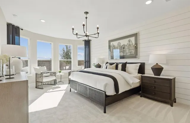 a spacious bedroom with a bed and window