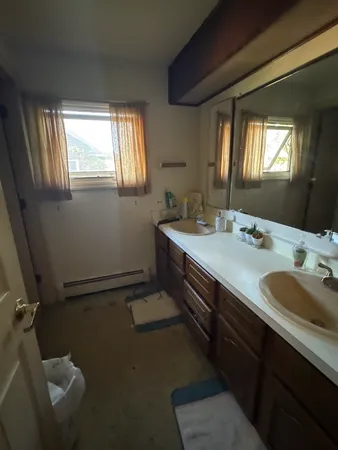 a bathroom with a double vanity sink and a mirror