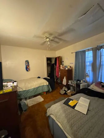 a bed sitting in a room next to a window