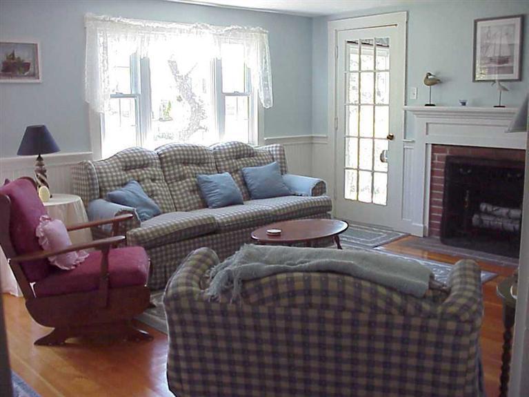 13 Beaten Road Dennis Port, MA 02639 - Photo 4 of 7 a living room with furniture a window and a fireplace