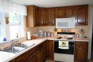 13 Beaten Road Dennis Port, MA 02639 - Photo 5 of 7 a kitchen with stainless steel appliances granite countertop a sink stove and microwave