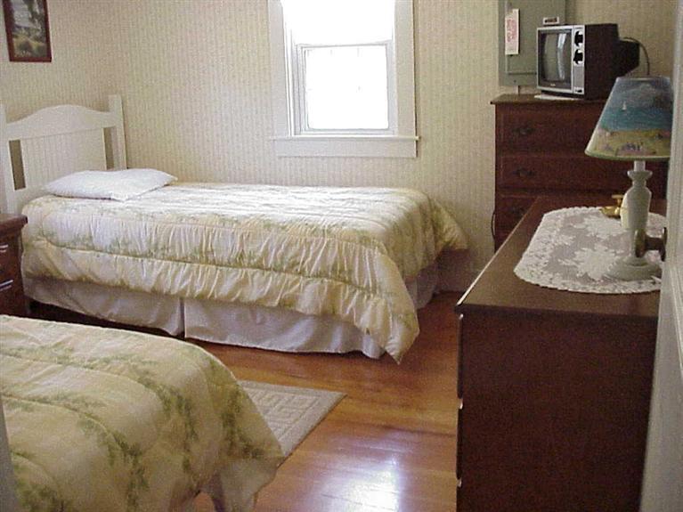 13 Beaten Road Dennis Port, MA 02639 - Photo 6 of 7 a bedroom with a bed and wooden floor