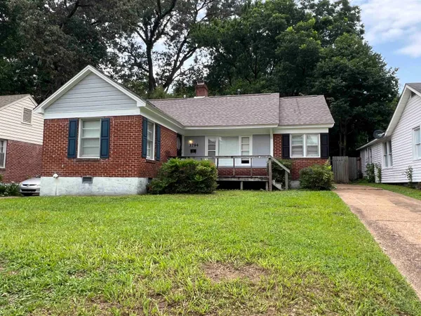 a front view of a house with a garden
