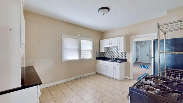 a kitchen with a stove and a refrigerator