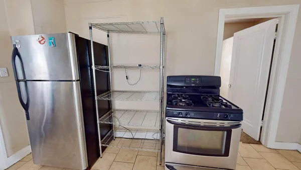 a kitchen with stainless steel appliances a refrigerator a stove and cabinets