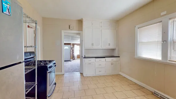 a kitchen with a refrigerator and a stove top oven