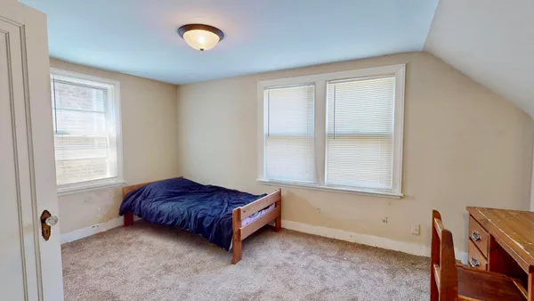 a living room with a bed and a window