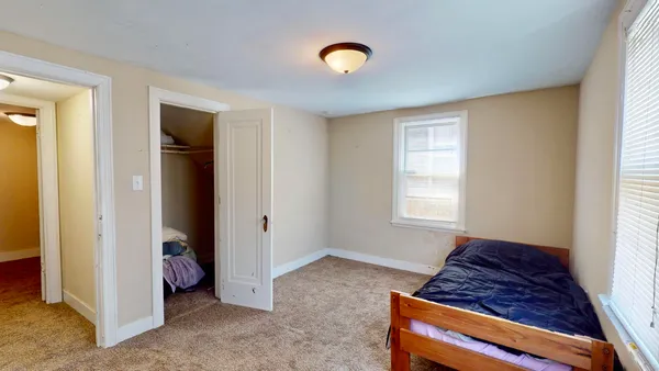 a living room with a bed and a window
