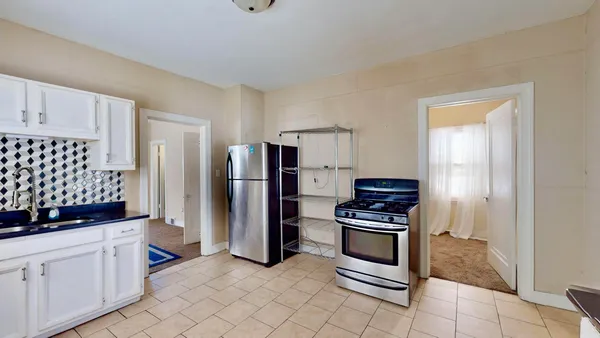 a kitchen with stainless steel appliances a refrigerator and a stove top oven