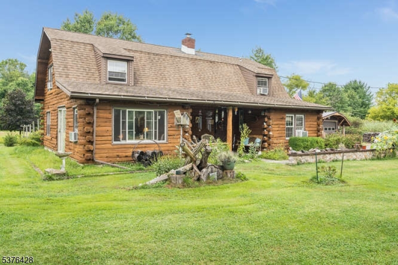 a front view of house with a garden and patio