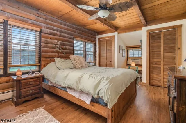 a large bed sitting in a bedroom next to a window