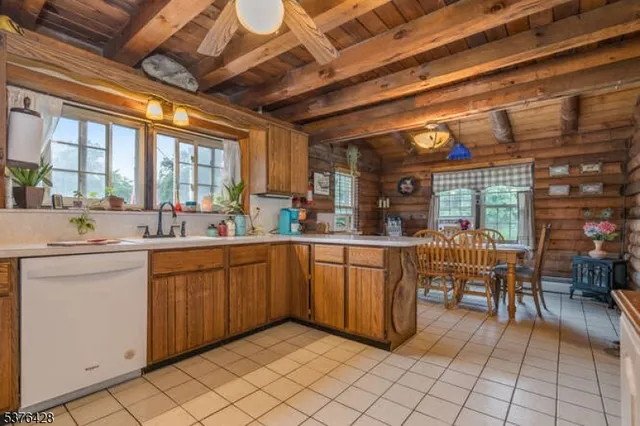 a kitchen with sink and wooden cabinets