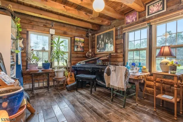 a living room with furniture a fireplace and large windows