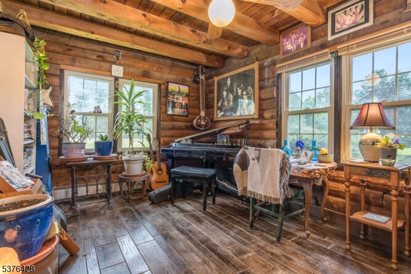 153 Hammar Road Frenchtown, NJ 08825 - Photo 9 of 24 a living room with furniture a fireplace and large windows