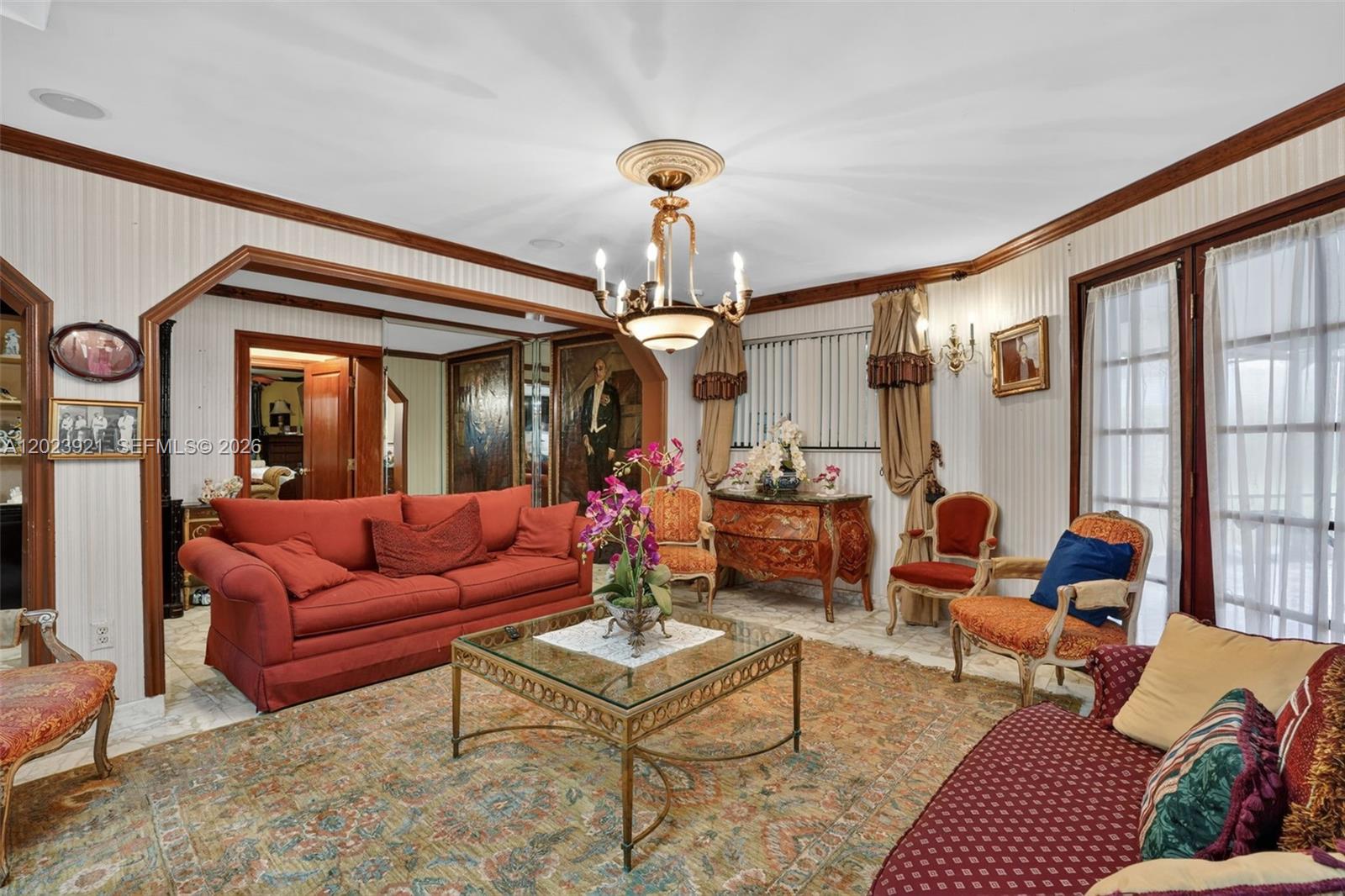 8461 Southwest 68th St Road Miami, FL 33143 - Photo 34 of 65 a living room with furniture a chandelier and a large window