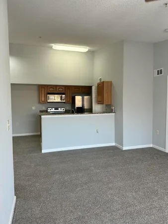 a view of a kitchen with stainless steel appliances cabinets