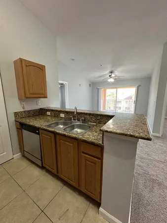 a kitchen with granite countertop a sink and a stove