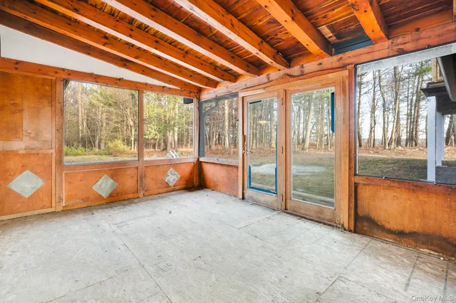 a view of a room with wooden walls