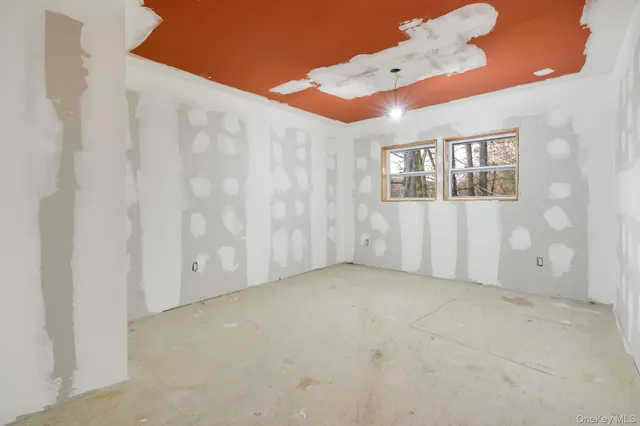 an empty room with windows and closet