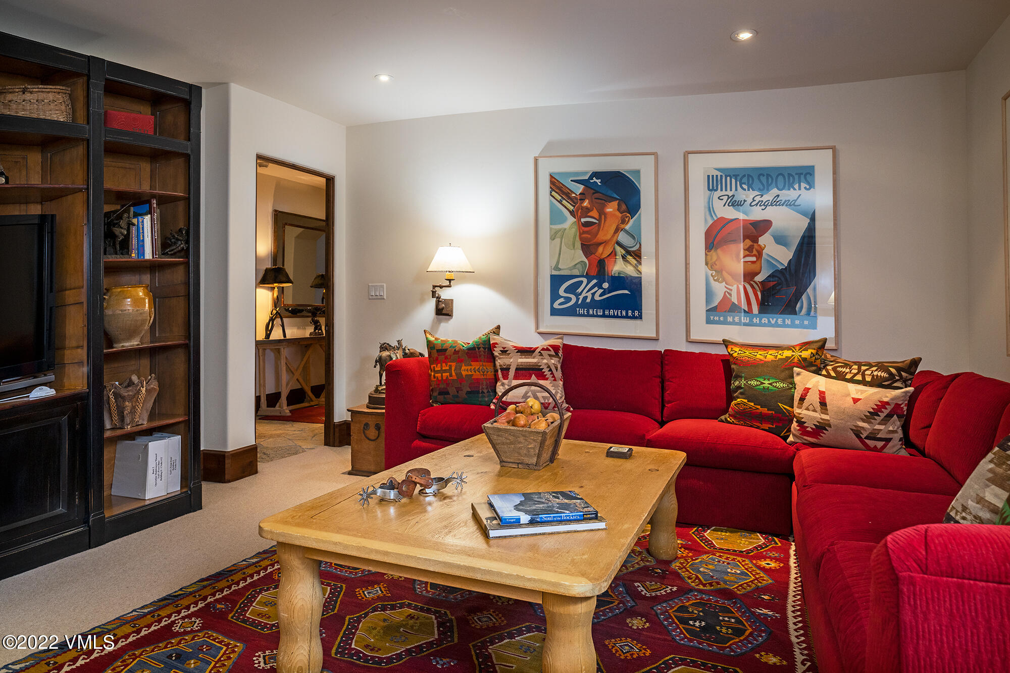 151 Vail Road, Unit 12 Vail, CO 81657 - Photo 15 of 22 a living room with furniture a bookshelf and a window