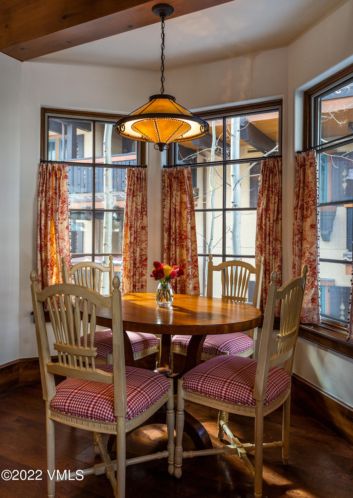 151 Vail Road, Unit 12 Vail, CO 81657 - Photo 8 of 22 a view of a dining room with furniture window and wooden floor